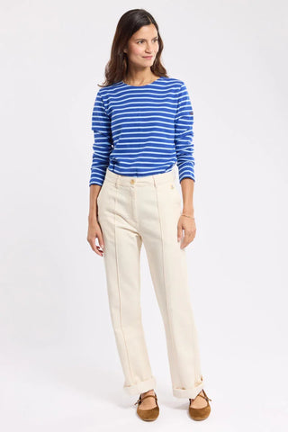 Woman wearing a blue striped long-sleeve top and cream high-waisted pants, casual style