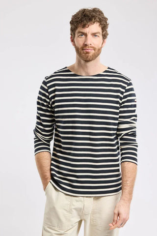 Man in navy and white striped long sleeve shirt with beige pants, casual fashion style