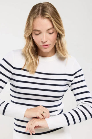 Woman wearing a white and navy striped long sleeve sweater, casual fashion style.