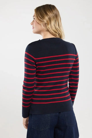 Woman wearing navy sweater with red horizontal stripes, seen from the back