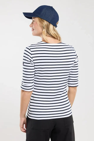 Woman wearing a navy and white striped shirt and denim cap, viewed from the back
