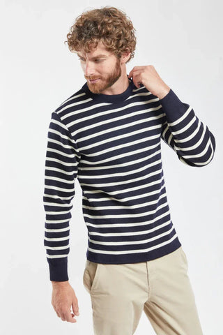 Man wearing navy and white striped crewneck sweater with beige pants