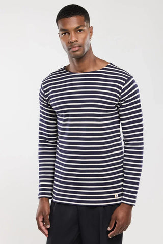 Man wearing navy and white striped long-sleeve shirt, casual fashion style