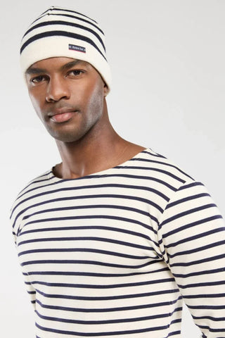 Man wearing navy and white striped beanie and matching striped shirt, casual fashion