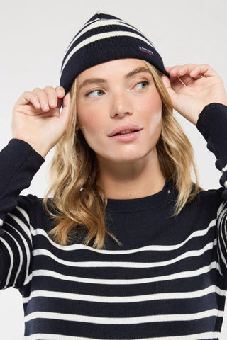 Woman wearing navy and white striped knit hat and sweater, nautical style fashion