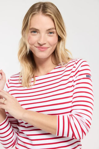 Woman wearing a red and white striped long-sleeve top, casual fashion style