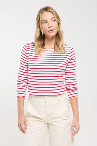Woman wearing red and white striped long sleeve shirt and beige pants, casual fashion