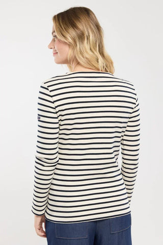 Woman wearing navy and white striped long-sleeve shirt, back view
