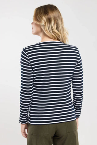 Woman wearing navy and white striped long sleeve shirt, photographed from the back