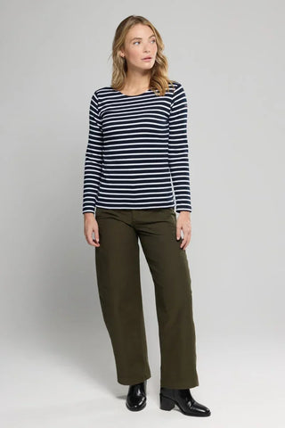 Woman wearing navy and white striped long sleeve shirt with olive green wide-leg pants