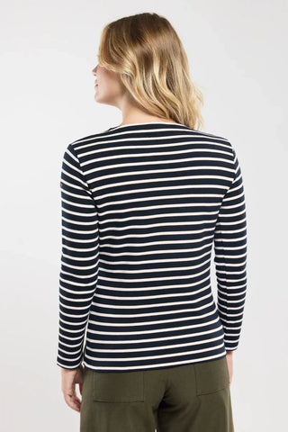 Woman wearing navy and white striped long sleeve shirt, back view, casual outfit
