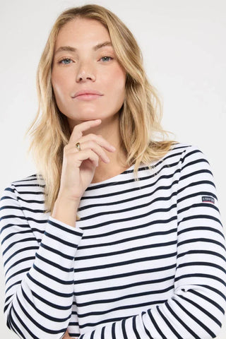 Woman wearing navy and white striped long sleeve shirt, casual fashion top