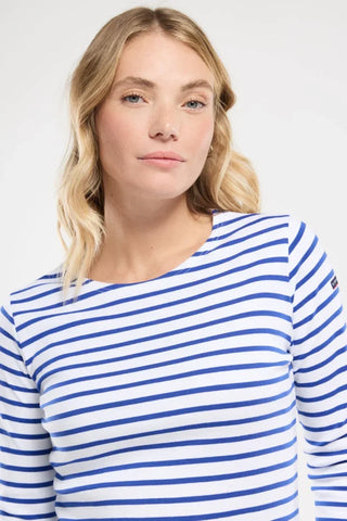 Woman wearing blue and white striped long sleeve shirt, nautical style