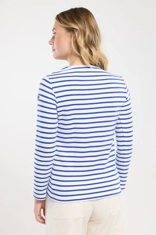 Woman wearing blue and white striped long sleeve shirt, back view, casual style.