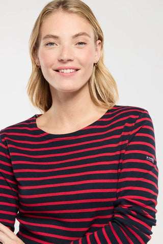 Woman wearing navy and red striped long-sleeve top, casual fashion style