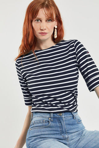 Woman in navy and white Breton striped 3/4 sleeve shirt and blue jeans, casual style