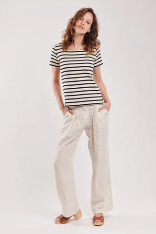 Woman wearing short-sleeve striped cotton top and wide-leg cream pants, casual outfit