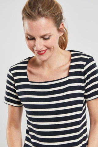 Woman wearing short-sleeve navy and white striped marinière top with square neckline