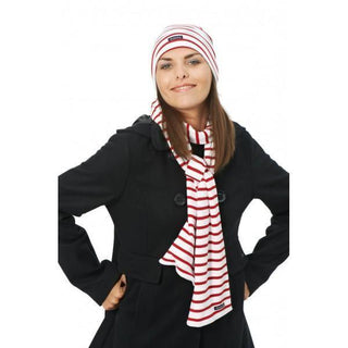 Woman in black coat wearing red and white striped cotton scarf and matching beanie
