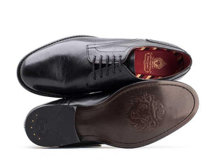 Men’s black leather lace-up dress shoes with embossed sole design and striped inner lining