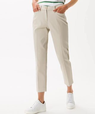 Beige cotton satin capri pants for women, styled with white sneakers, cropped fit