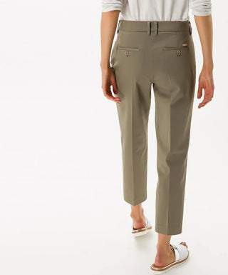 Woman wearing khaki cotton satin capri pants, back view, cropped fit, casual style