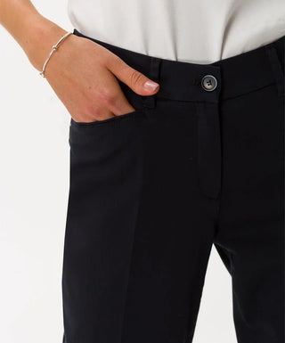 Close-up of woman wearing black cotton satin capri pants with hand in pocket