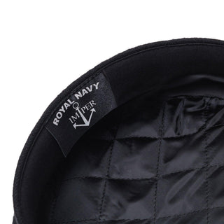Close-up of black wool captain's cap with quilted satin lining and ROYAL NAVY label