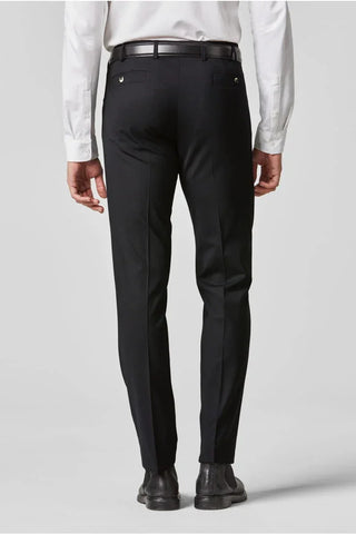 Back view of man wearing black dress pants, white shirt, black belt and dress shoes