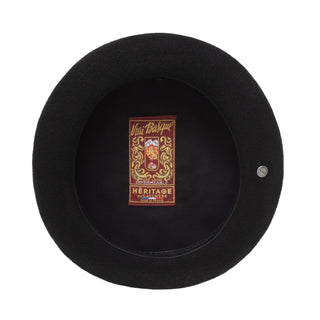 Interior view of a black Basque beret with embroidered heritage label and round brim.