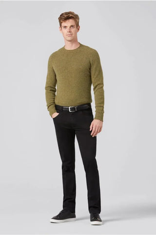 Man wearing olive green sweater and black Meyer cotton pants with black sneakers