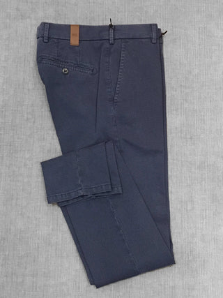 Folded navy blue textured men's dress pants with belt loops and buttoned back pocket
