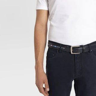 Men's black leather belt with nautical flag details and silver buckle, styled with dark pants