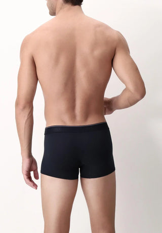 Back view of man wearing black boxer briefs, seamless waistband, minimal background
