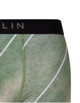 Close-up of green men's boxer briefs with black waistband and white diagonal stripes.